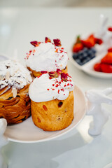 decorated panettones and cruffins on serving plates with rabbits. easter cakes. 