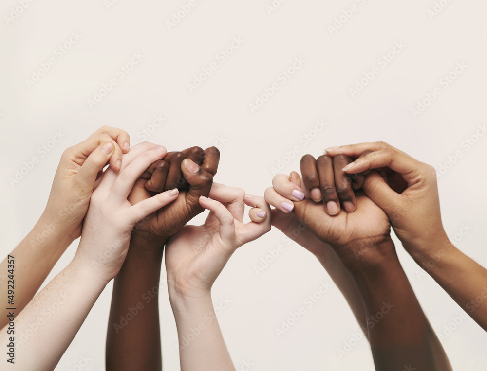 Poster true support. cropped shot of a group of hands reaching up and holding on to each other.