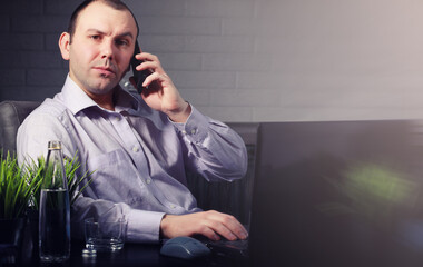 man at table and working on laptop
