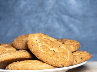 Oatmeal cookies in a plate.  Cookies with raisins on the table.  Sweet treat. Healthy diet.