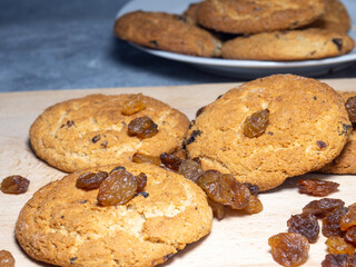 Oatmeal cookies in a plate. Cookies with raisins on the table. Raisins on the table. Sweet treat. Healthy diet.