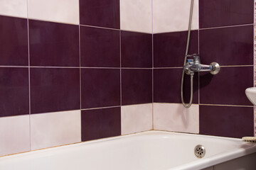 Bathroom in an apartment in Ukraine with white-red tiles, bathroom interior of a residential...