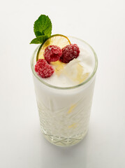 Milkshake with raspberries on a white background