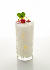 Milkshake with raspberries on a white background