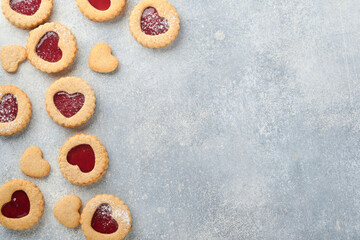 Traditional Linzer cookie with strawberry jam and powder sugar on light grey beautiful background. Top view. Traditional homemade Austrian sweet dessert food on Valentines Day. Holiday snack concept.