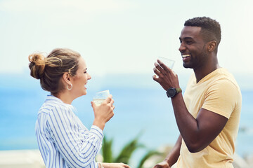 We deserved this holiday after the year weve had. Shot of a young couple enjoying drinks together while relaxing outdoors on holiday.