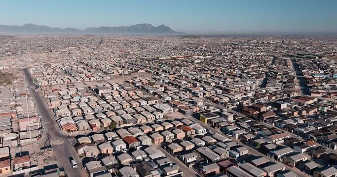 Poverty.Inequality.Aerial close-up fly over view of the densely populated Khayelitsha township on the Cape Flats, Cape Town, South Africa