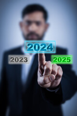 man choosing 2024 year on digital screen blur background