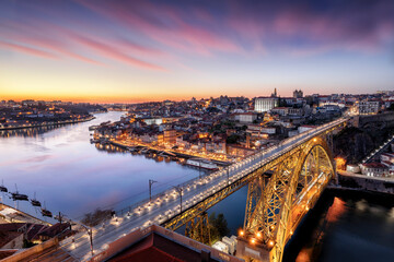 Fototapeta na wymiar Porto, Portugal. Panoramic cityscape of Porto, Portugal - in front the famous Luis I Bridge and the Douro River during dramatic sunset