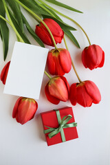 beautiful bouquet of pink tulips and a gift box with a pink bow 