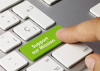 Support our mission - Inscription on Green Keyboard Key.