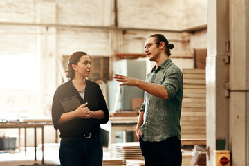 Were always discussing ways of growing our business. Cropped shot of two young carpenters at work...
