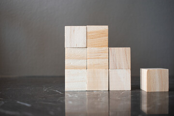 Nine wooden blocks arranged in 3 x 3 cube