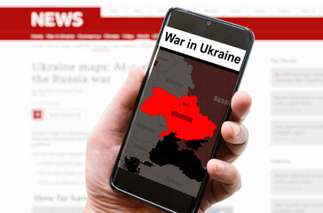 War in Ukraine on mobile phone screen, media news concept