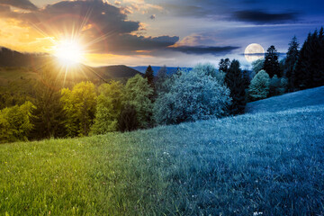 day and night time change in carpathian mountains. beautiful nature scenery in spring. landscape with fresh green meadows and forest with sun and moon. clouds on the sky above the distant ridge