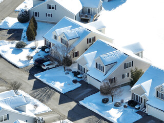 aerial view of residential house and community in winter after snow