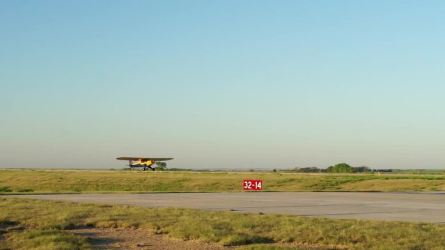 Small high wing airplane landing at rural airport USA