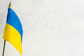 In the left corner of the photo is the state flag of Ukraine on a white background. There is free space to insert. Peaceful state, patriotism, freedom, Independence Day, Constitution Day.