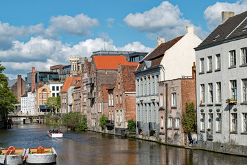 Fototapeta na wymiar Apartment buildings line a canal in Ghent, Belgium.