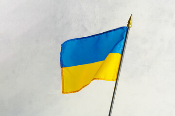 The national flag of ukraine flutters on a white background. An independent sovereign state, a peaceful country, the path to the European Union, Russia's aggression against Ukraine.
