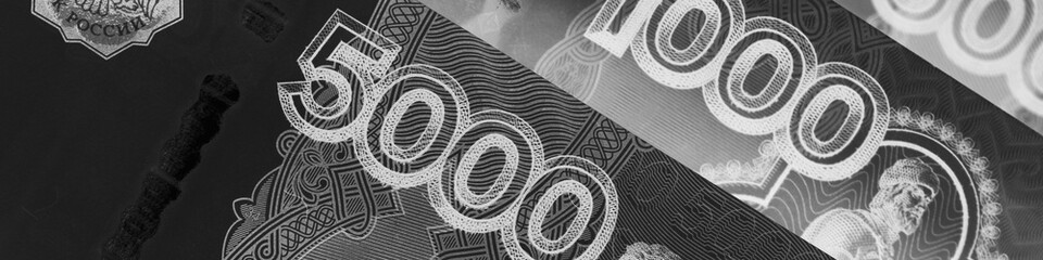 Russian banknotes 5000, 1000 and 500 rubles. Numerals of denominations of bills closeup. Dark black...