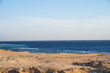 Fototapeta na wymiar Deep blue sea waves hit cliffs in the Red Sea, Hurgharda, Egypt