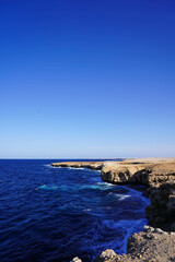 Fototapeta premium Deep blue sea waves hit cliffs in the Red Sea, Hurgharda, Egypt