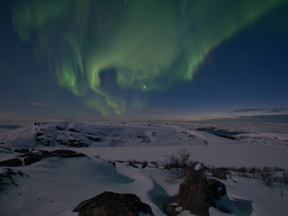 Beautiful aurora borealis in the tundra in winter.