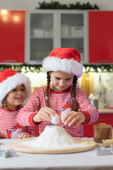 happy funny children boy and girl bake Christmas cookies. Christmas baking, festive gingerbread cookies 