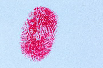 Red fingerprint on white paper