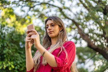 A woman using her smartphone outdoors.