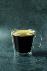 A transparent glass of coffee