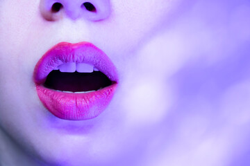 open female lips on a purple background