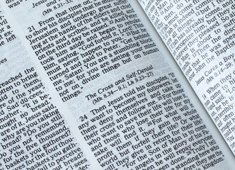 Obraz premium The cross and self-denial gospel verses. The teaching of God Jesus Christ. The biblical concept of studying the Christian Holy Bible Book. A closeup.