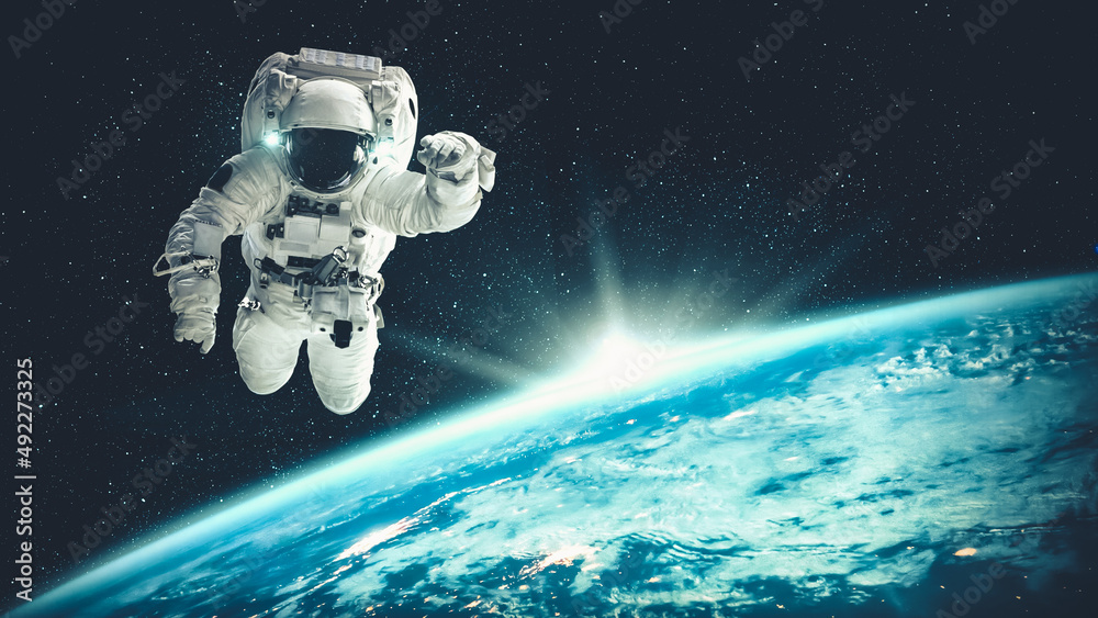Wall mural astronaut spaceman do spacewalk while working for spaceflight mission at space station . astronaut w