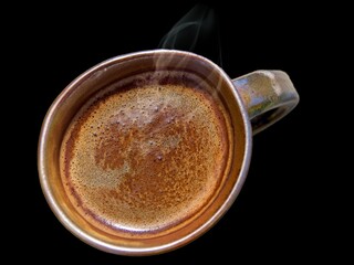 Cup of coffee view from the top against black background