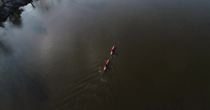 Ukraine. Kyiv. A couple on a canoe float on the river. Autumn. Desna river