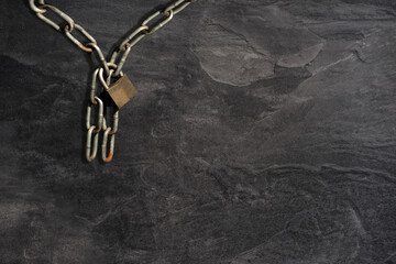 iron chains and lock against black background, the concept to honor the memory of the dead, closed