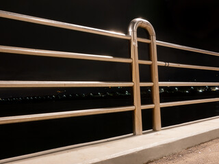 night view of a shiny stainless steel railing