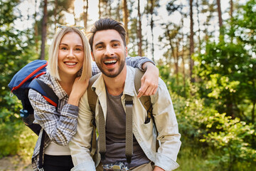 Portrait of laughing couple hiking together in the woods