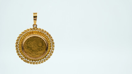 Monogram gold pendant on white background