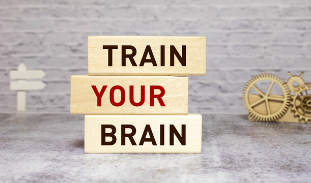 An image of plastic letters saying use your brain. Image is taken against a wooden table