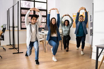 Group Of Happy Young Businesspeople Doing Stretching Exercise