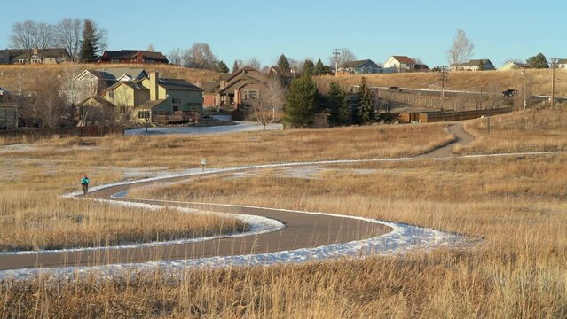 senior male cyclist is riding a gravel bike on a meandering bike trail, winter afternoon in Cathy Fromme Prairie Natural Area in Fort Collins, Colorado