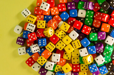 Top view of dozens of six-sided dice of many colors