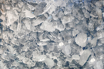 Abstract ice texture. Icy chunks on the surface. Top view close up. Fragments of crystals of...