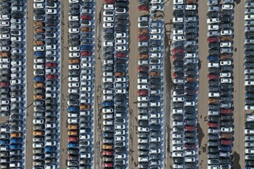 Straight vertical aerial view on cars on the parking lot on a bright summer day
