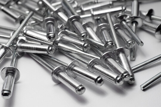 Aluminum rivets on white isolate.Macrophotography of chrome rivets. A tool for fixing metal parts. Rivets for fastening.