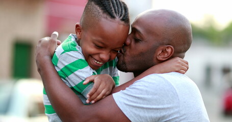 Father and son love care and affection. African dad cuddling with child son