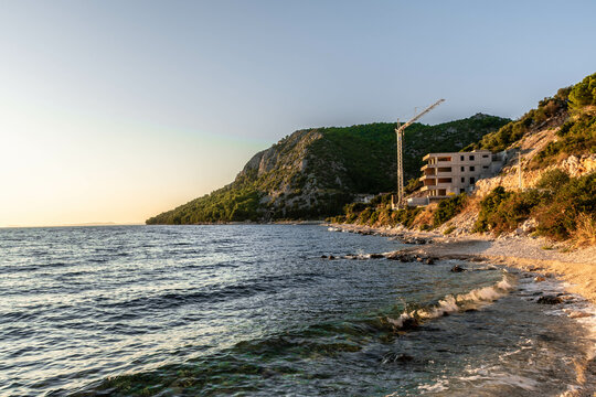the outline of the mountains at sunset, the shore of the adriatic sea in croatia, summer sunset by the sea